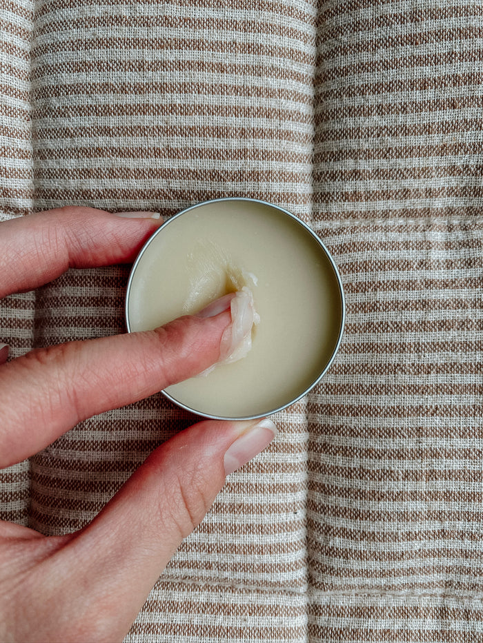 Soothe Facial Balm 1 oz tin, tallow face balm, open in hand